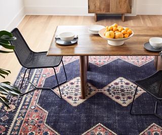 A blue area rug in a dining room