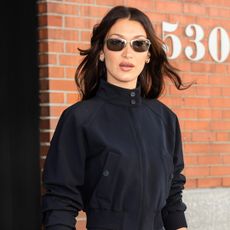 Bella Hadid wears a black jacket and the capri pants trend while in New York City