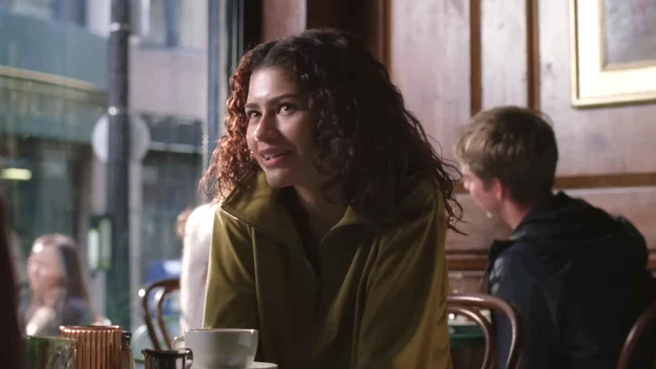 Zendaya sitting at a cafe in The Drama