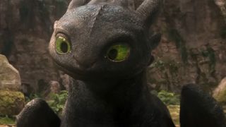 A shot of toothless looking curious by a rock wall in How To Train Your Dragon.