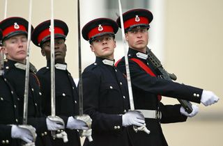 Kate Middleton wears a bright red coat to attend Prince William's pass out parade at Sandhurst on December 15, 2006