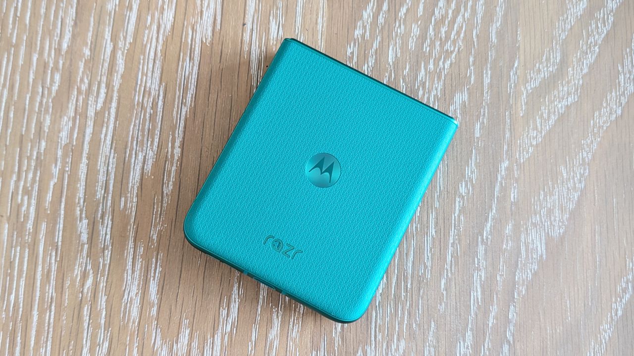Motorola Razr 2026 in blue, being held in the hand