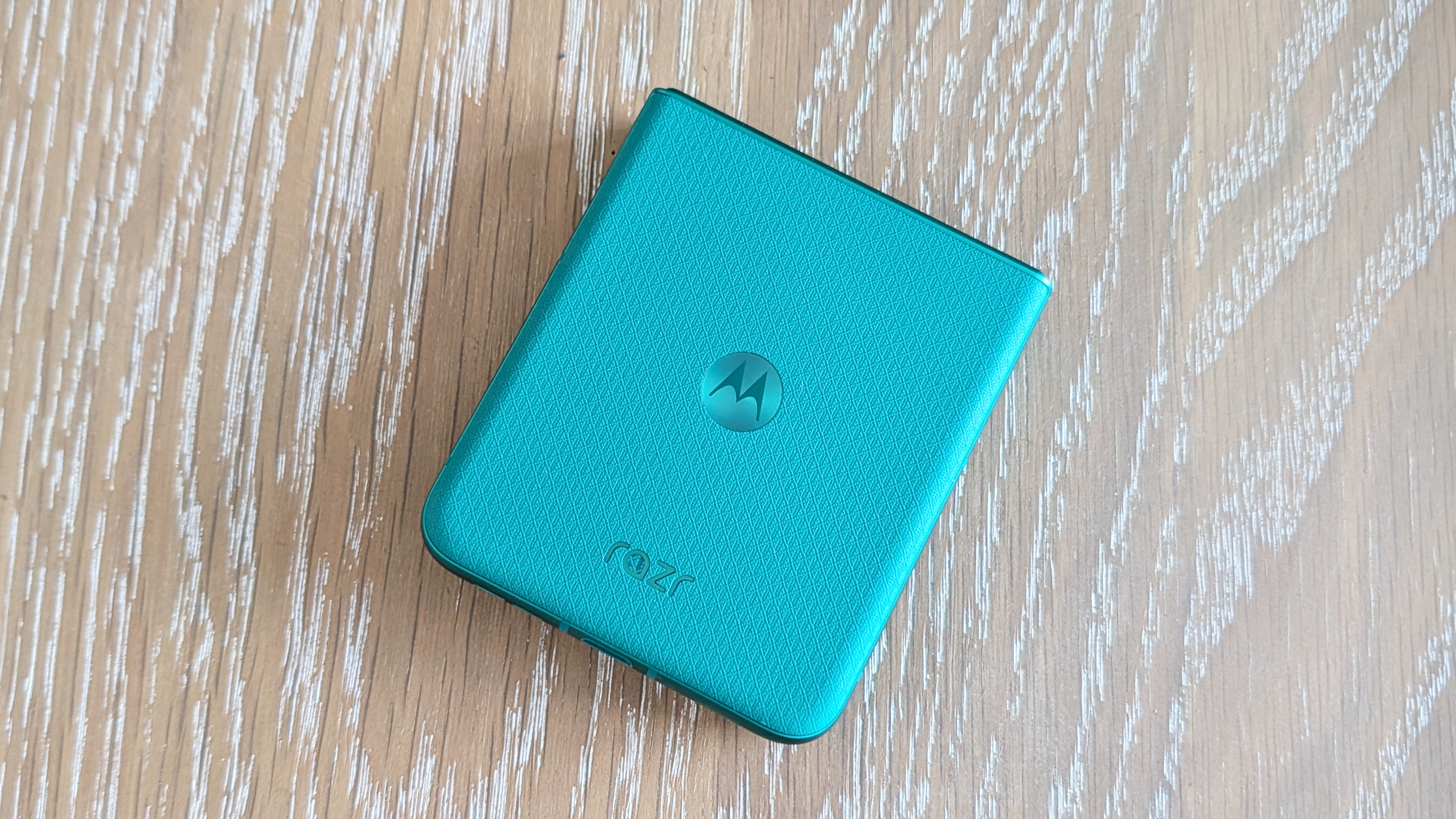 Motorola Razr 2026 in blue, being held in the hand