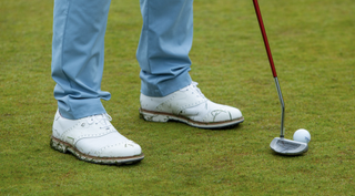 FootJoy Wilcox shoes and an Odyssey putter close up