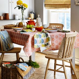 dining room with dining table chairs and colourful fabrics