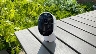 Arlo Pro 4 on its magnetic mount table in the garden