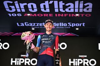 Derek Gee of Canada and Team Israel-Premier Tech celebrates at podium as Most Combative Prize winner during the 106th Giro d'Italia 2023