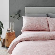 bedroom with grey bed and pink beddings