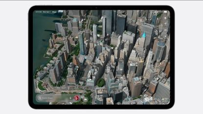 An iPad showing a 3D-rendered aerial view of a city in Apple Maps 