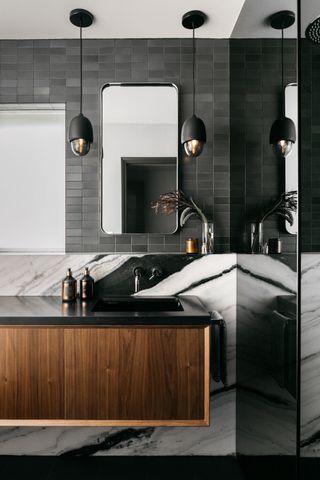 a black bathroom with marble vanity