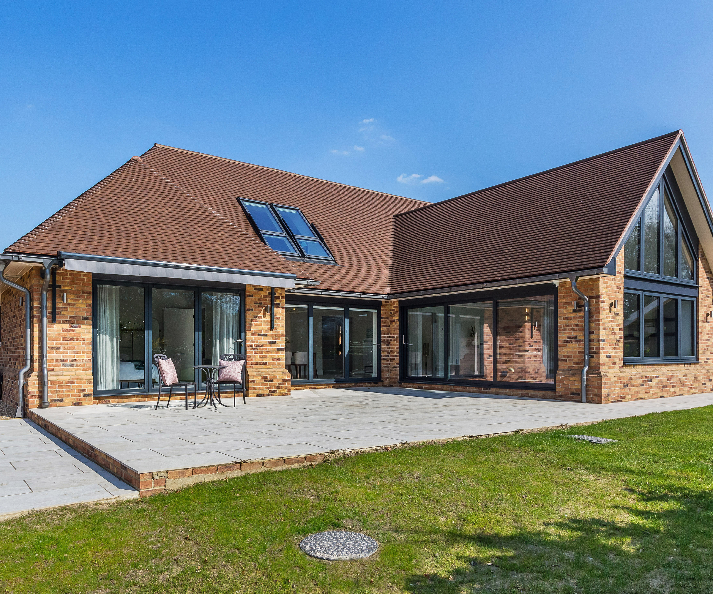 brick clad timber frame house with tiled pitched roof and gable end