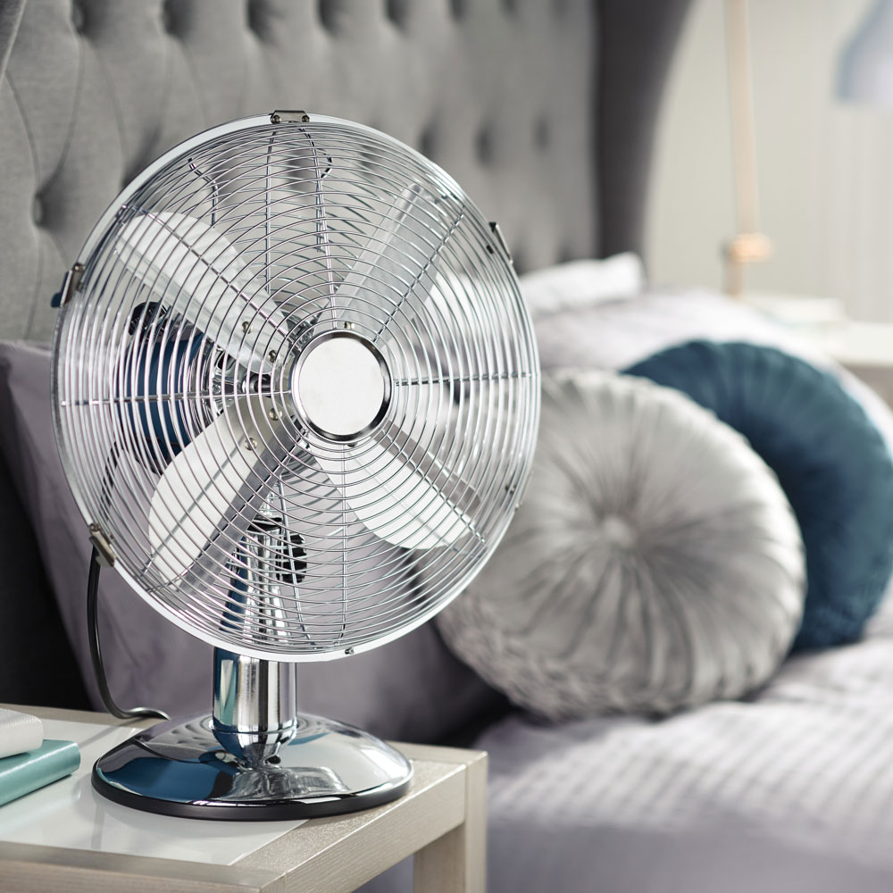 silver colour aldi retro desk fan with wooden table