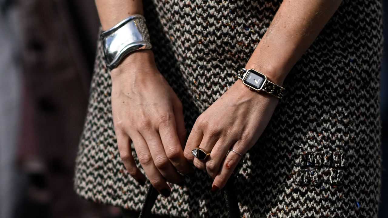 A guest is seen with a black Miu Miu bag outside the Miu Miu show during the Womenswear Spring/Summer 2024 as part of Paris Fashion Week on October 03, 2023 in Paris, France. 