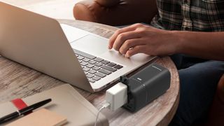 Best power bank: a man charging his Mac with a power bank