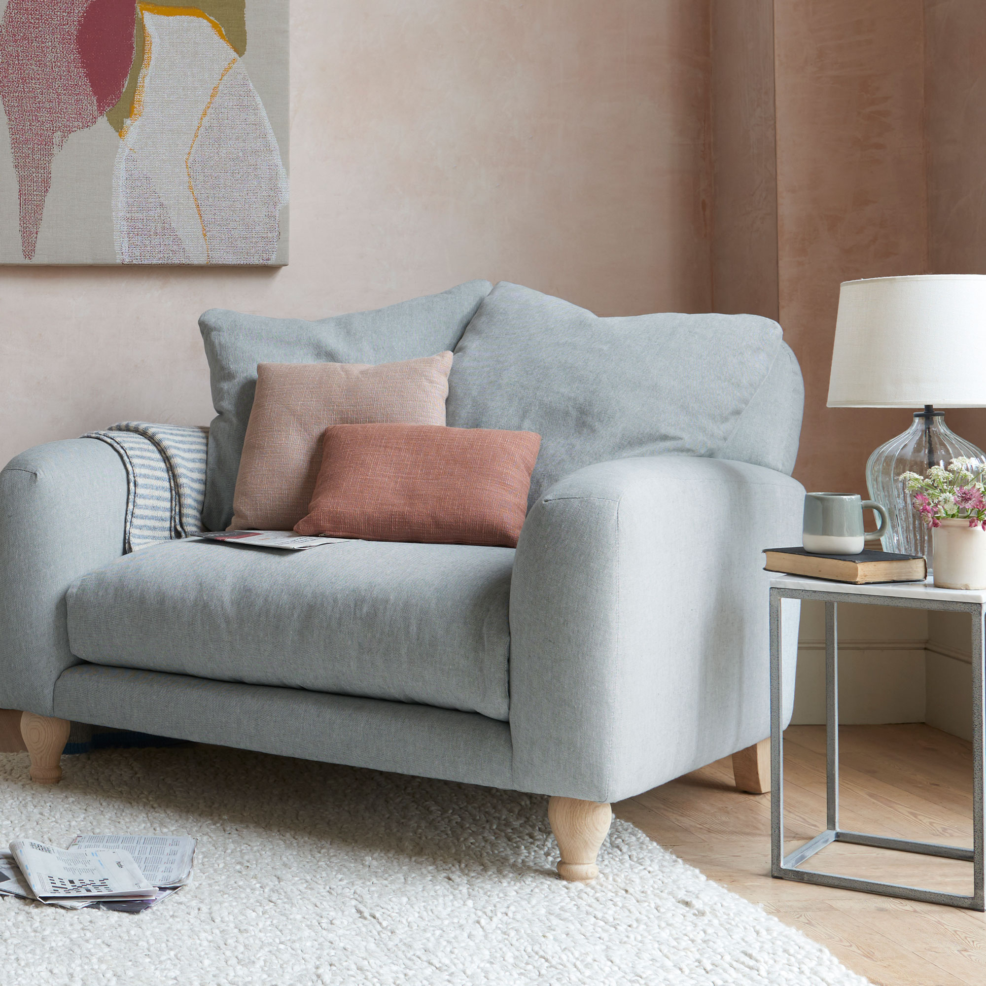 grey linen loveseat in pink living room with cream rug