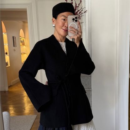 Irene kim wearing a black wool coat