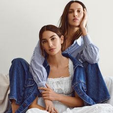 Lily and Ruby Aldridge wearing the Gap x Dôen collaboration in front of a plain backdrop
