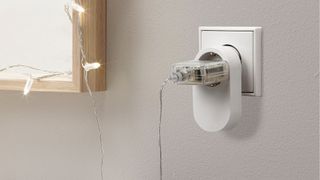 Ikea Trådfri, en trådløs kontakt ved et speil montert på en vegg.