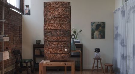 Installation view of a gallery focused on artisanal furniture, artworks, and sculptures, filled with one-off pieces in wood, ceramics, leather, and textile.