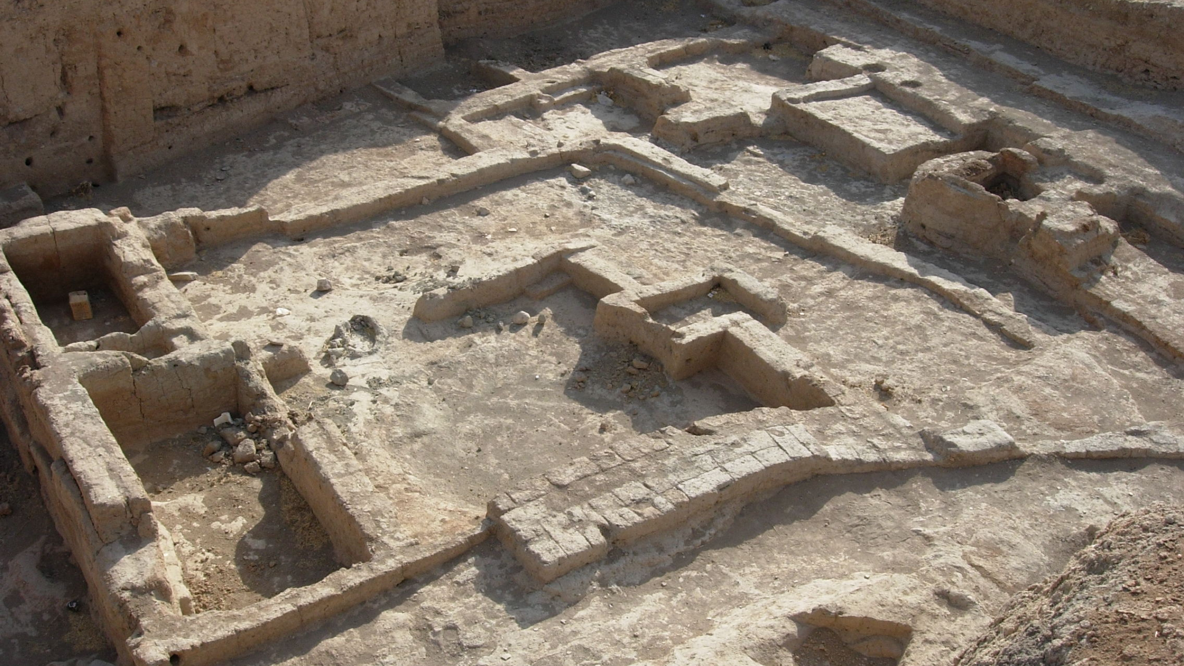 Series of walled structures in an excavation site.