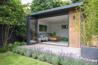 garden room with decked terrace edged by lavender