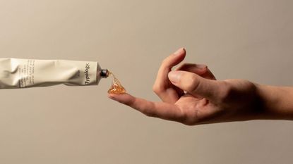 Typology skincare being put on finger