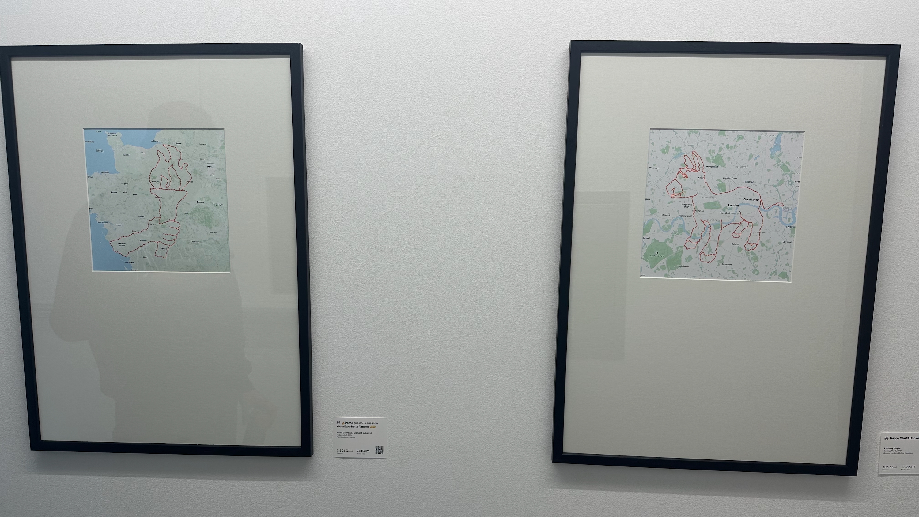 Two framed GPS artworks showing an Olympic torch in France and a donkey in London.