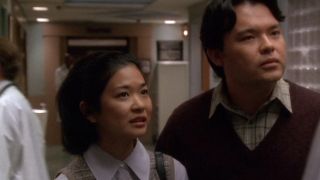 Keiko Agena and another man looking concerned in ER