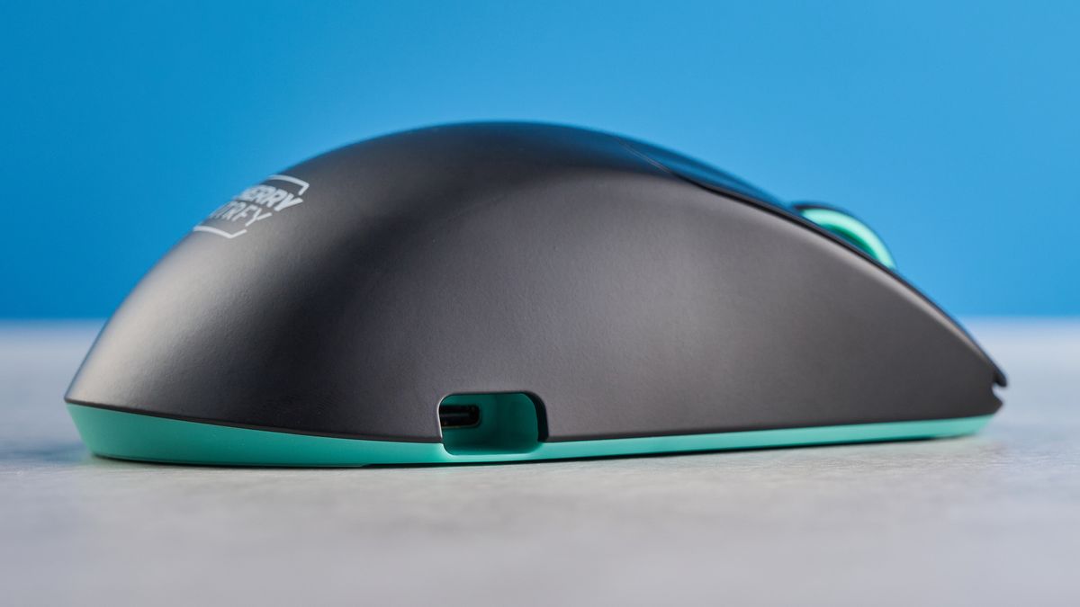 A black and teal Cherry XTRFY M64 Wireless gaming mouse
