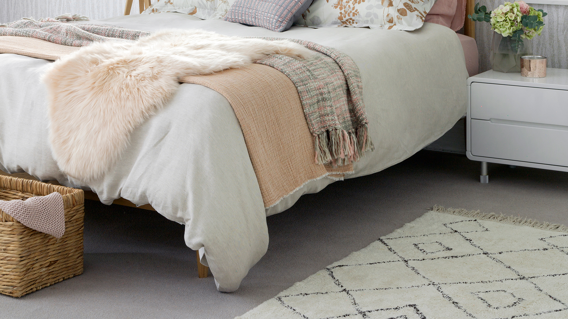 neutral bedroom with a thick pile rug beside the bed