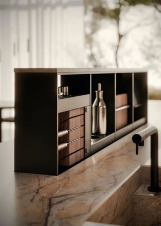 A kitchen island with electronic lift-up storage and inside it is a glass bottle for oil and a place for holding knives.