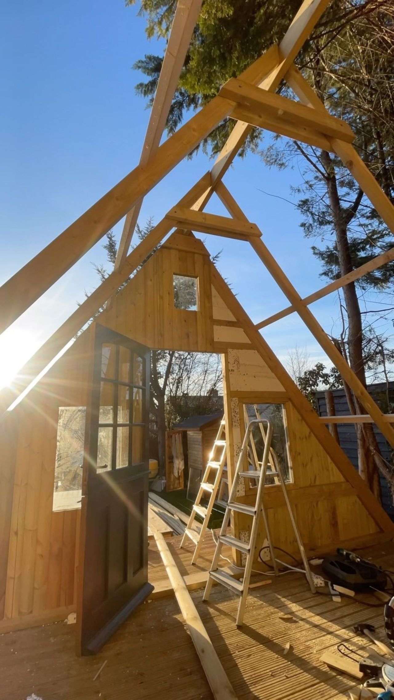 The wooden frame of the garden shed in a chalet style