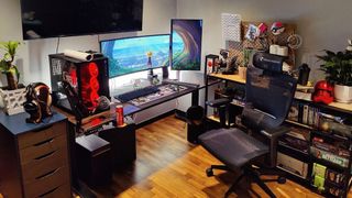 An image of the ErgoTune Supreme V3 in a decked-out gaming room, with high-end gaming PC, multiple monitors and gaming peripherals and other hardware.