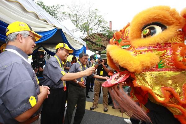 Officials are greeted by the race mascot