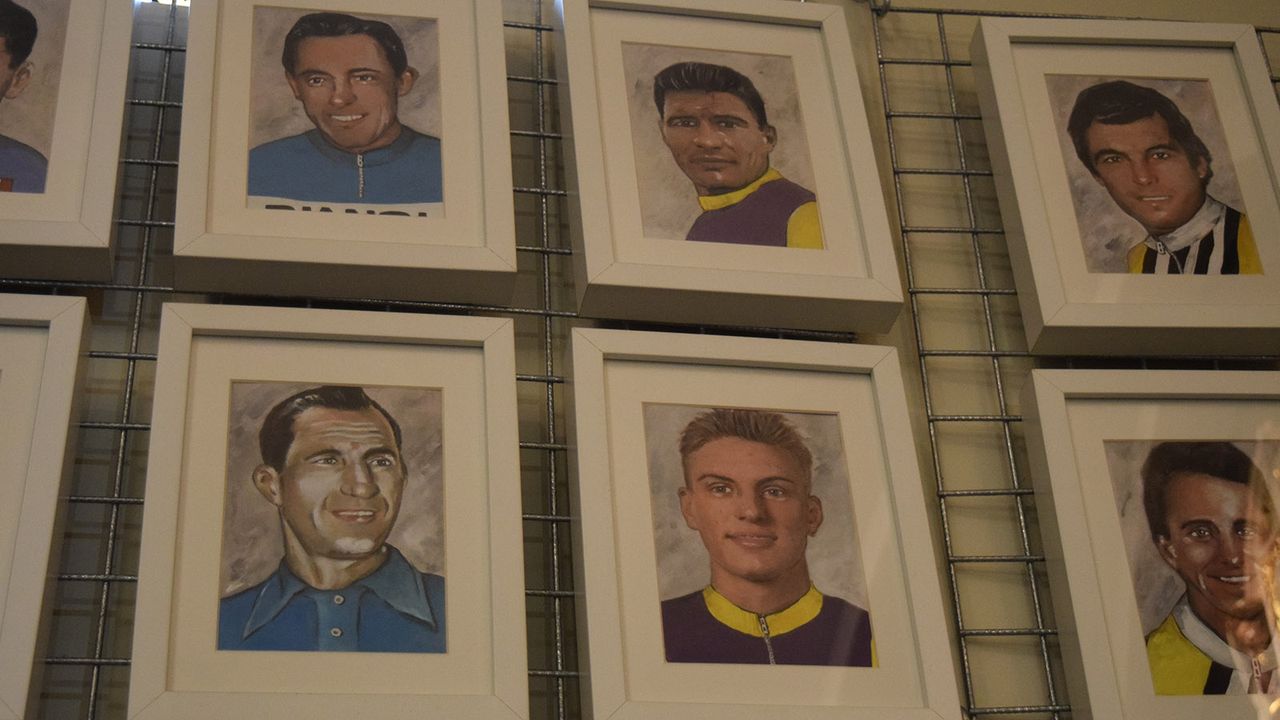 The wall features portraits of riders from the past up to present day