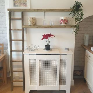 room with white wall and ladder and shelves