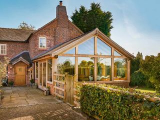 an oak frame extension on a traditional home