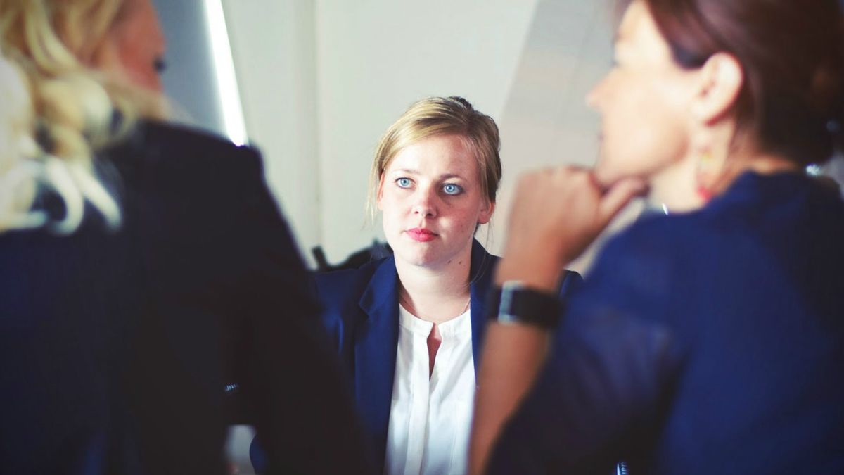 Girl being interviewed by two women