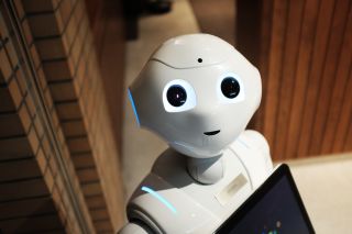 Humanoid robot looks up with smiling expression