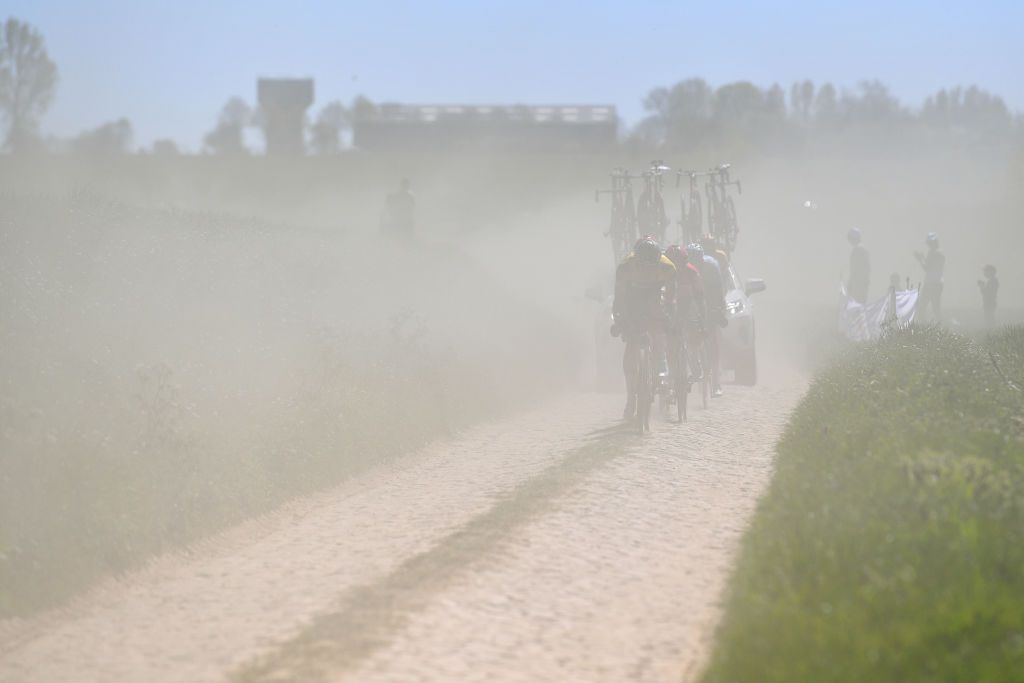 ROUBAIX FRANCE APRIL 17 A general view of Mike Teunissen of Netherlands and Team Jumbo Visma Victor Campenaerts of Belgium and Team Lotto Soudal Brent Van Moer of Belgium and Team Lotto Soudal compete passing through a dusty cobblestones sector during the 119th ParisRoubaix 2022 Mens Elite a 2572km one day race from Compigne to Roubaix ParisRoubaix WorldTour on April 17 2022 in Roubaix France Photo by Luc ClaessenGetty Images