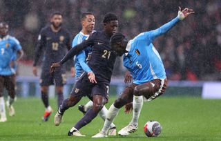 Kobbie Mainoo of England takes on Youri Tielemans and Amadou Onana of Belgium during the international friendly match between England and Belgium at Wembley Stadium on March 26, 2024 in London, England. (Photo by Alex Livesey - Danehouse/Getty Images) Euro 2024