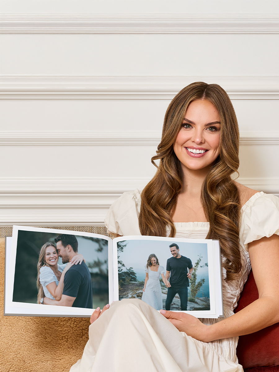 Hannah Brown holding a photo book.