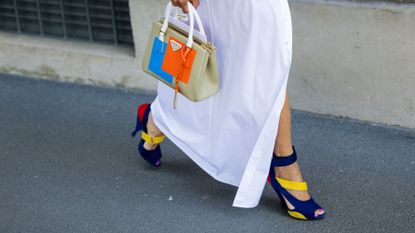 a woman walking in a colourful outfit - popsicle nails