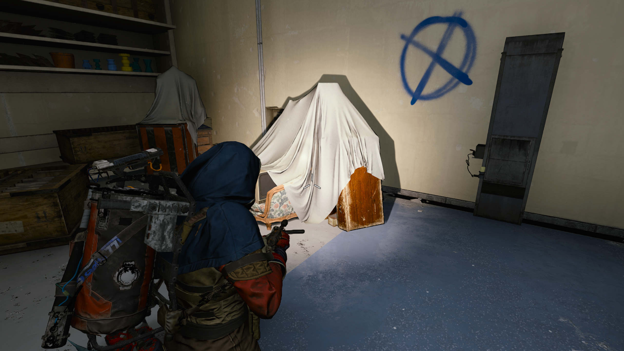 Arc Raiders Movie Night: A player looking at a pile of old furniture in a dark room, using a flashlight.