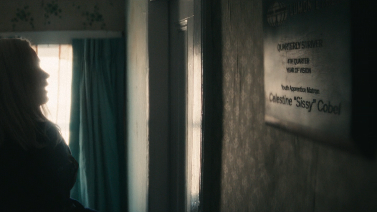 A shot of Sissy's Lumon Industries plaque hung on a wall in Severance season 2 episode 8