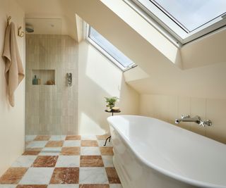 loft conversion bathroom with walk in shower, brown and white chequerboard marble floor tiles, freestanding bath and different tiles in shower area