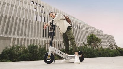 best electric scooter: person posing with the Pure Advance electric scooter