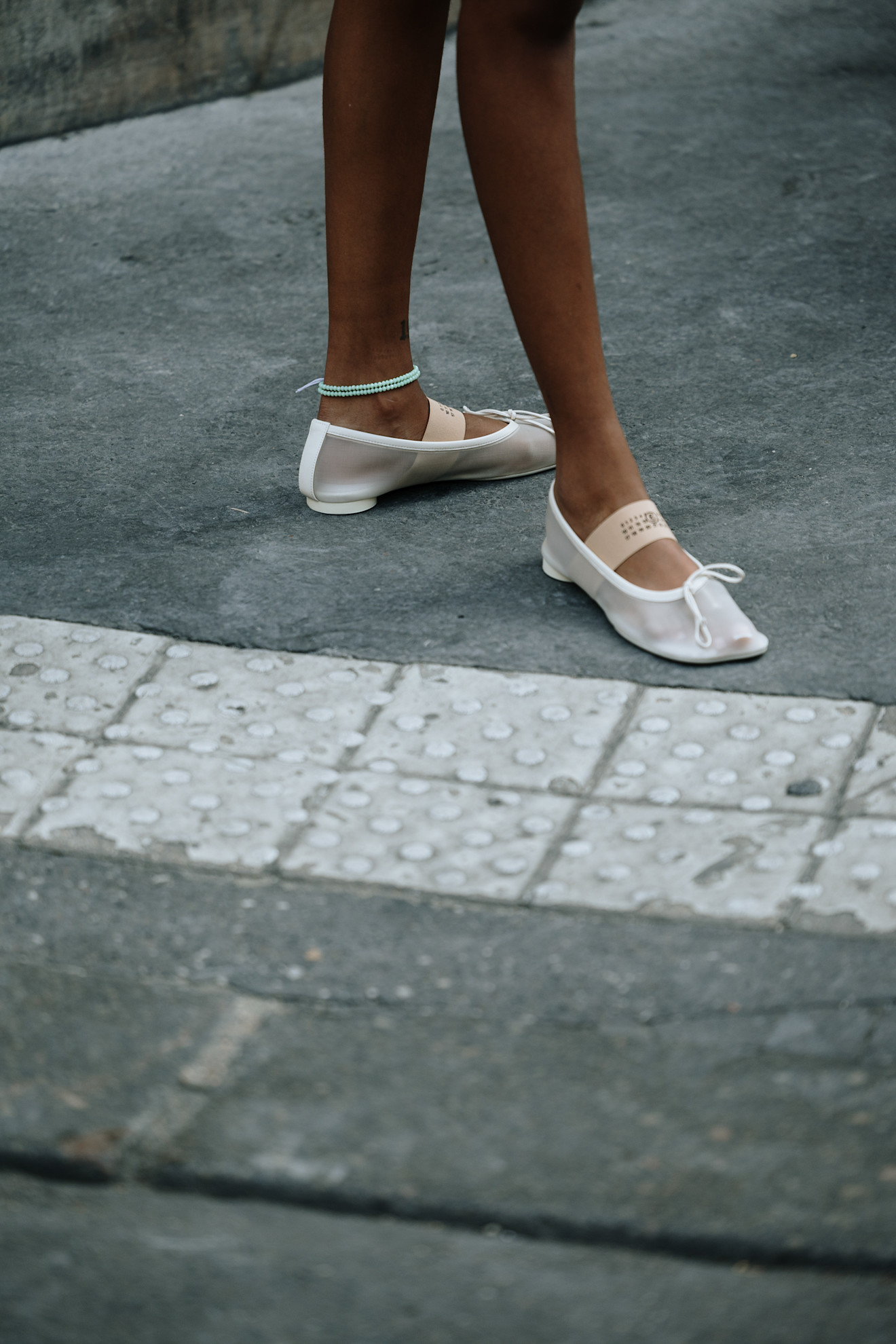 woman wearing white mesh flats