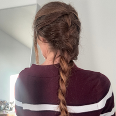 Eleanor Vousden's hair in a French braid, photographed from the back