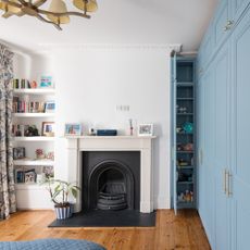 bedroom with blue fitted wardrobes and fireplace